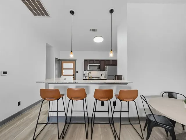 a bathroom with a granite countertop sink a mirror and shower