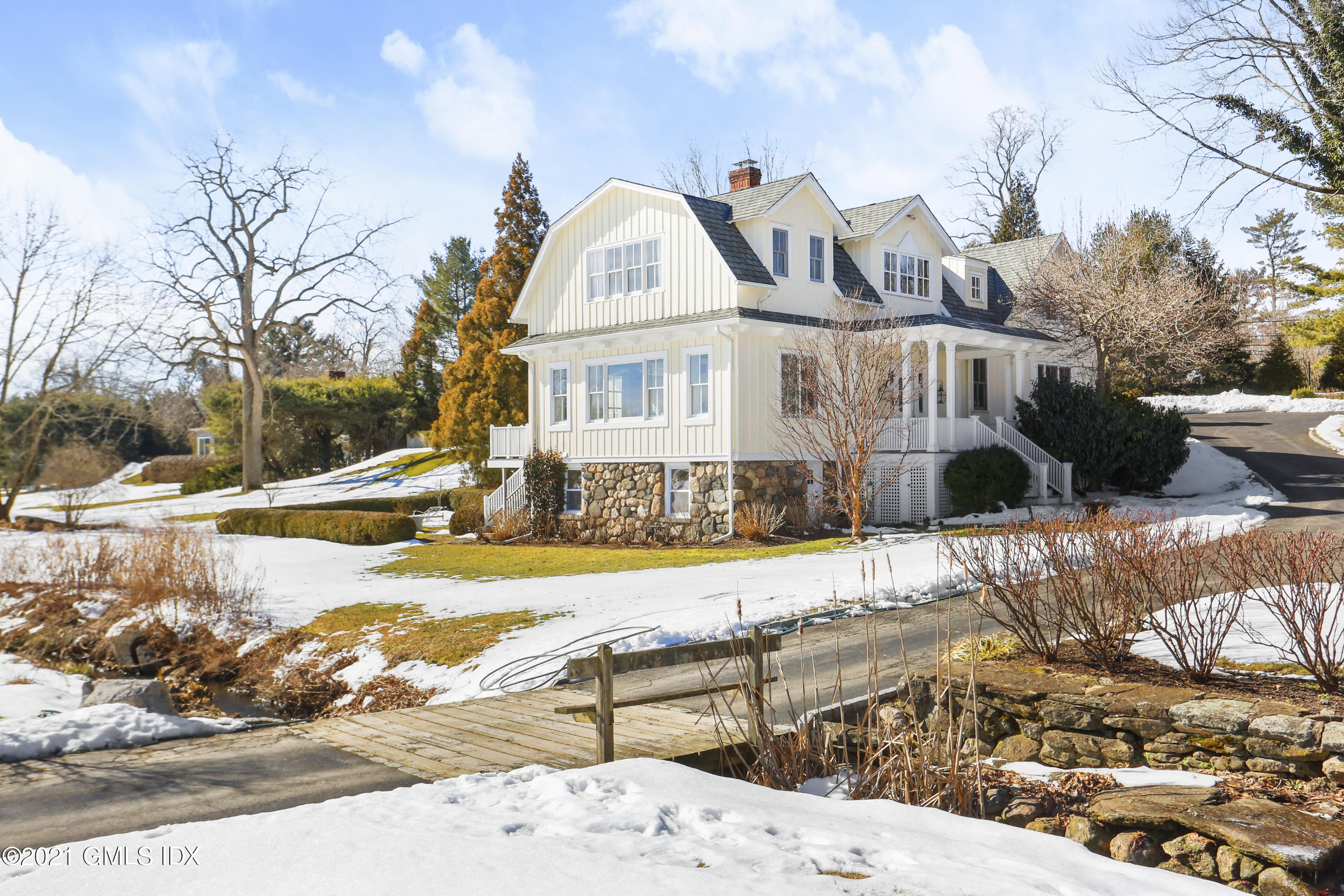 a view of a house with snow on the road