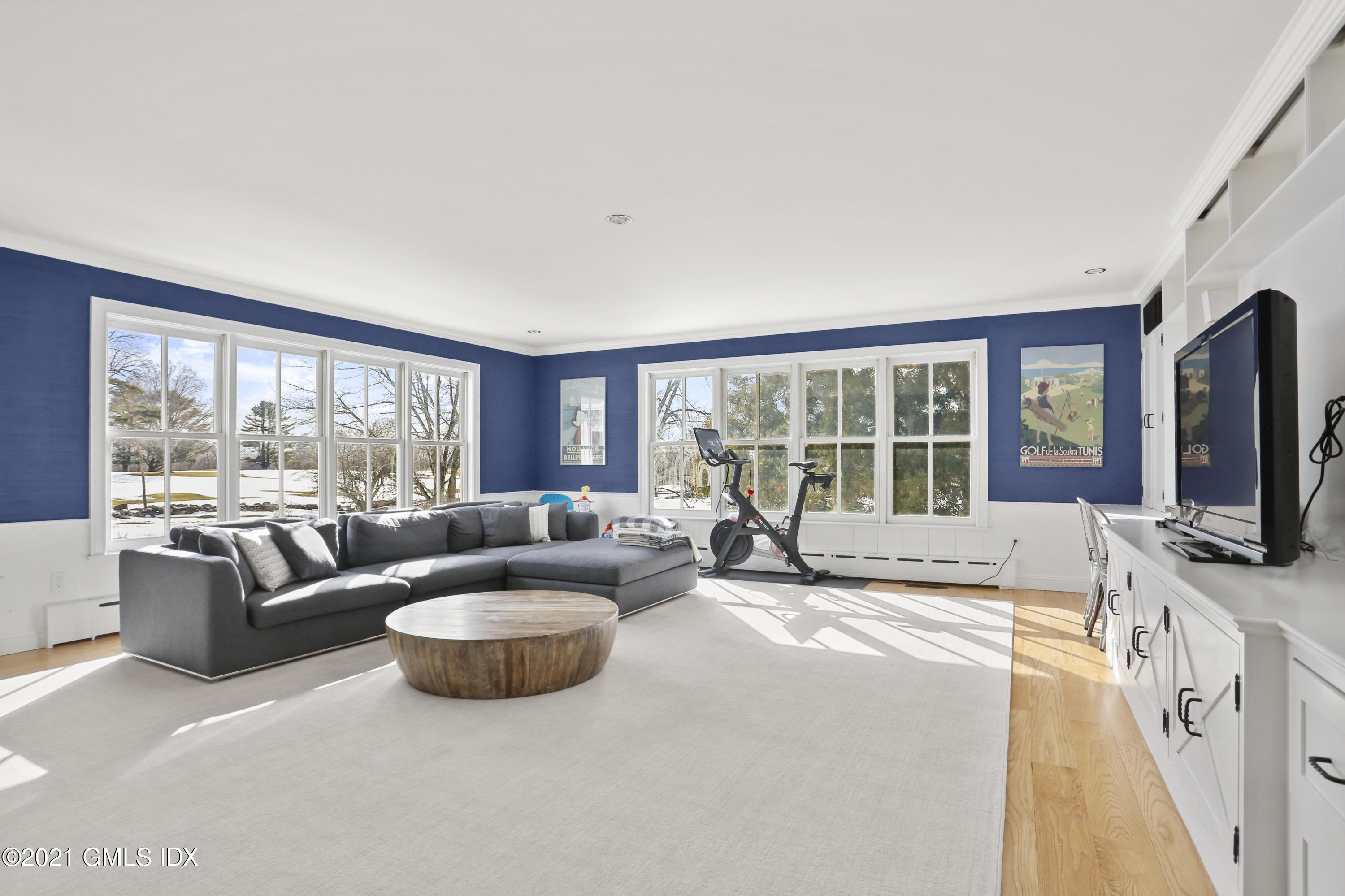 6 Golf Club Road Greenwich, CT 06830 - Photo 12 of 29 a living room with furniture large windows and a flat screen tv