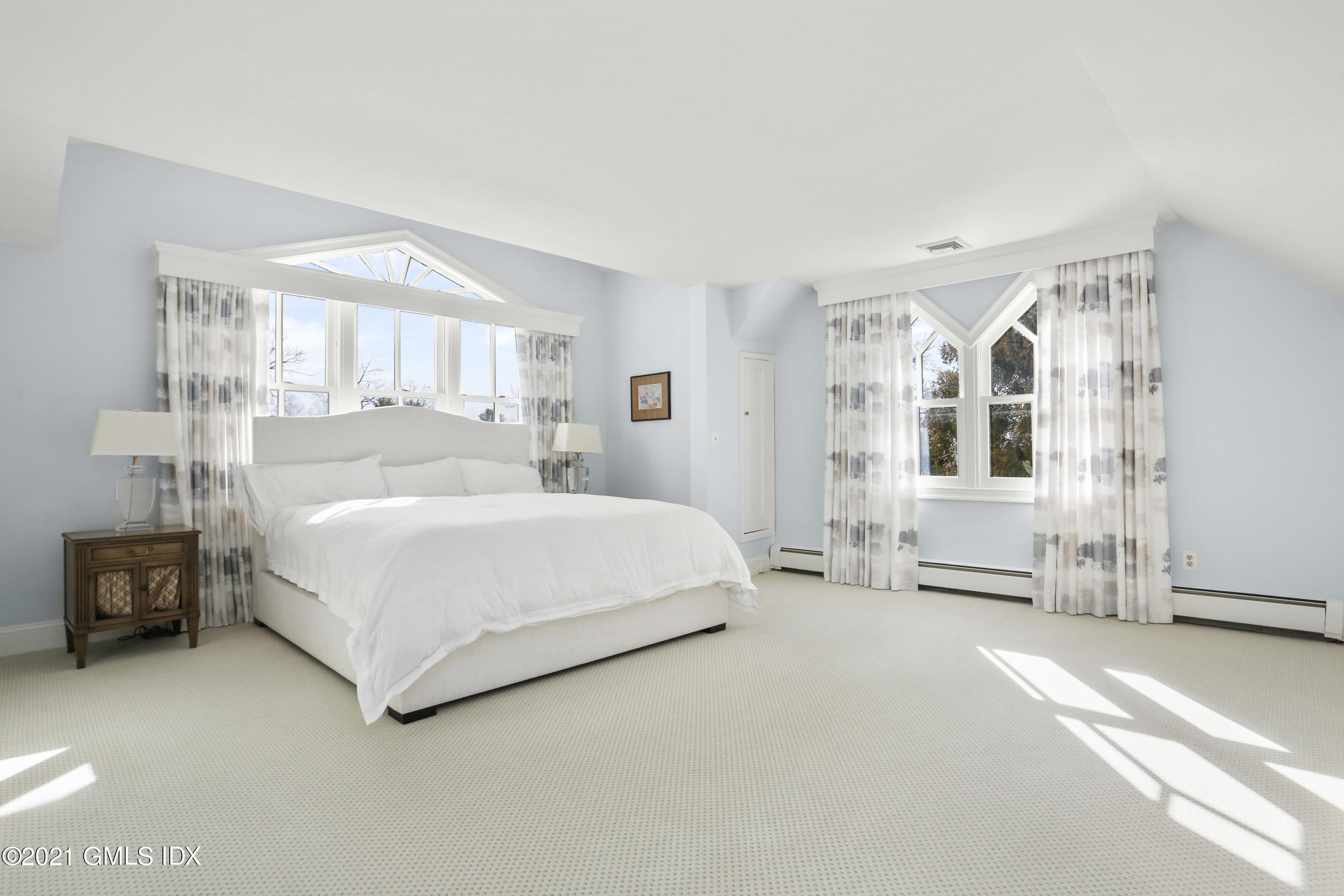 6 Golf Club Road Greenwich, CT 06830 - Photo 13 of 29 a spacious bedroom with a bed couch and a window