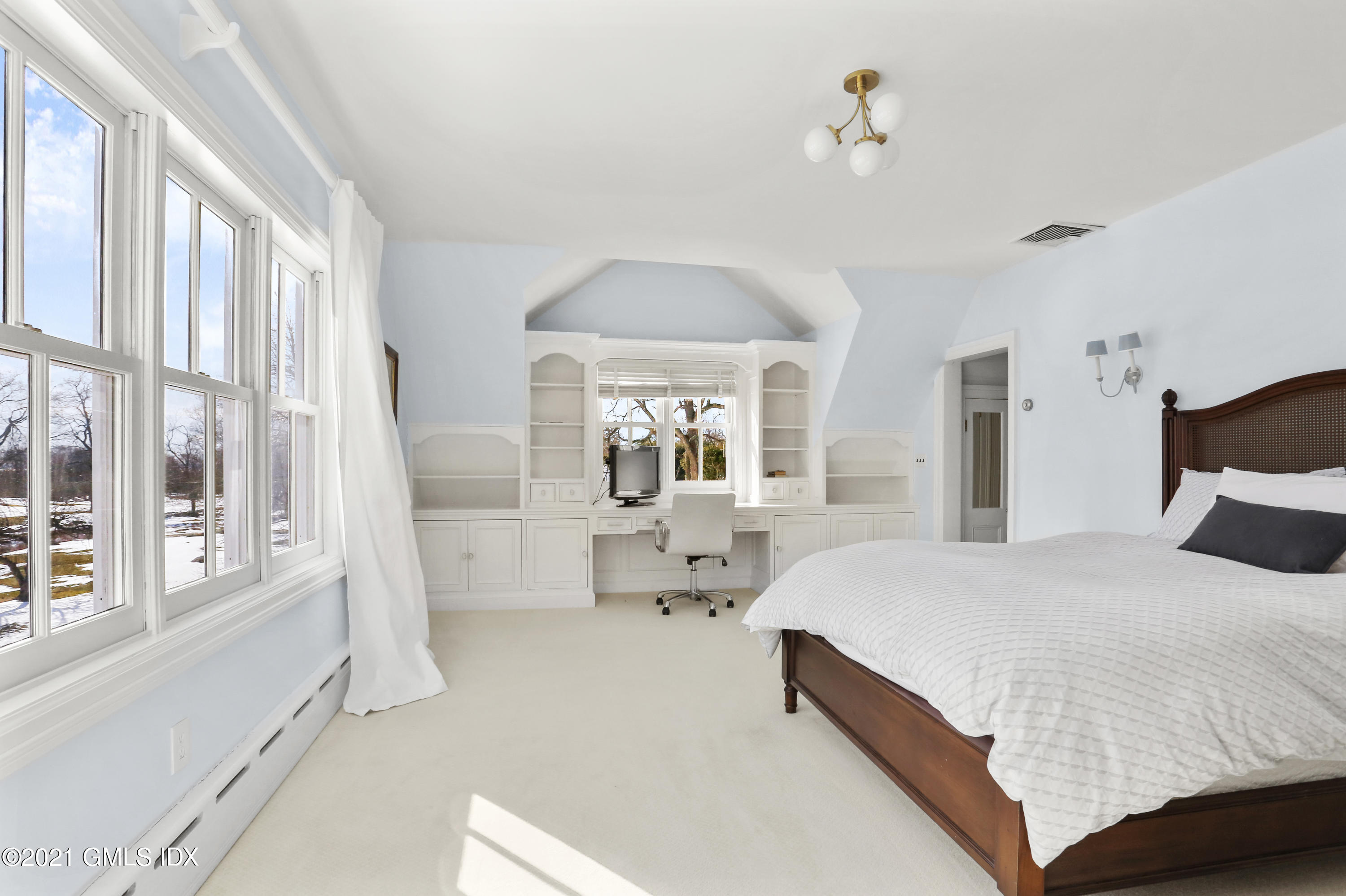 6 Golf Club Road Greenwich, CT 06830 - Photo 19 of 29 a bedroom with a large bed and a large window