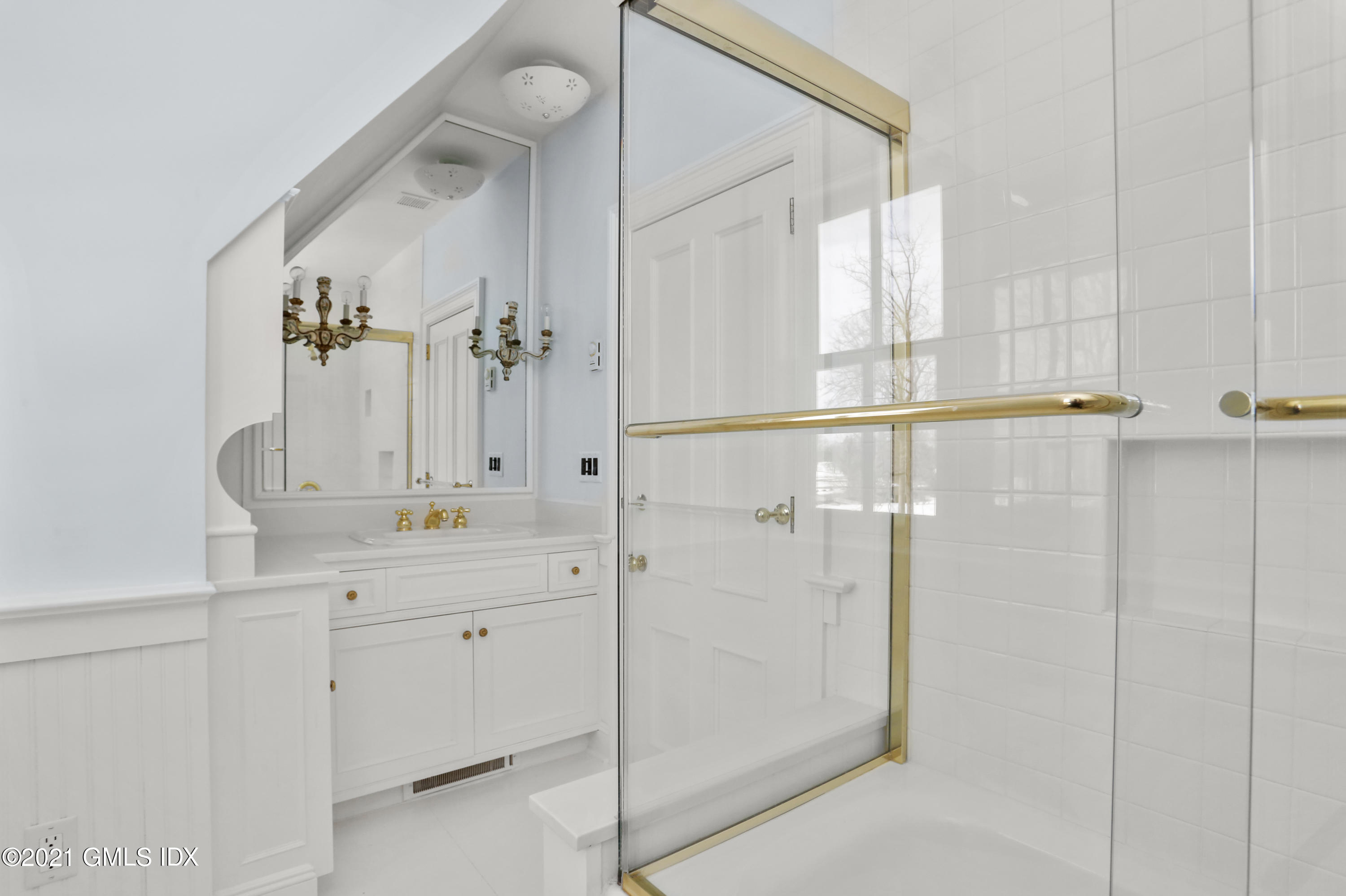 6 Golf Club Road Greenwich, CT 06830 - Photo 20 of 29 a bathroom with a shower sink and mirror