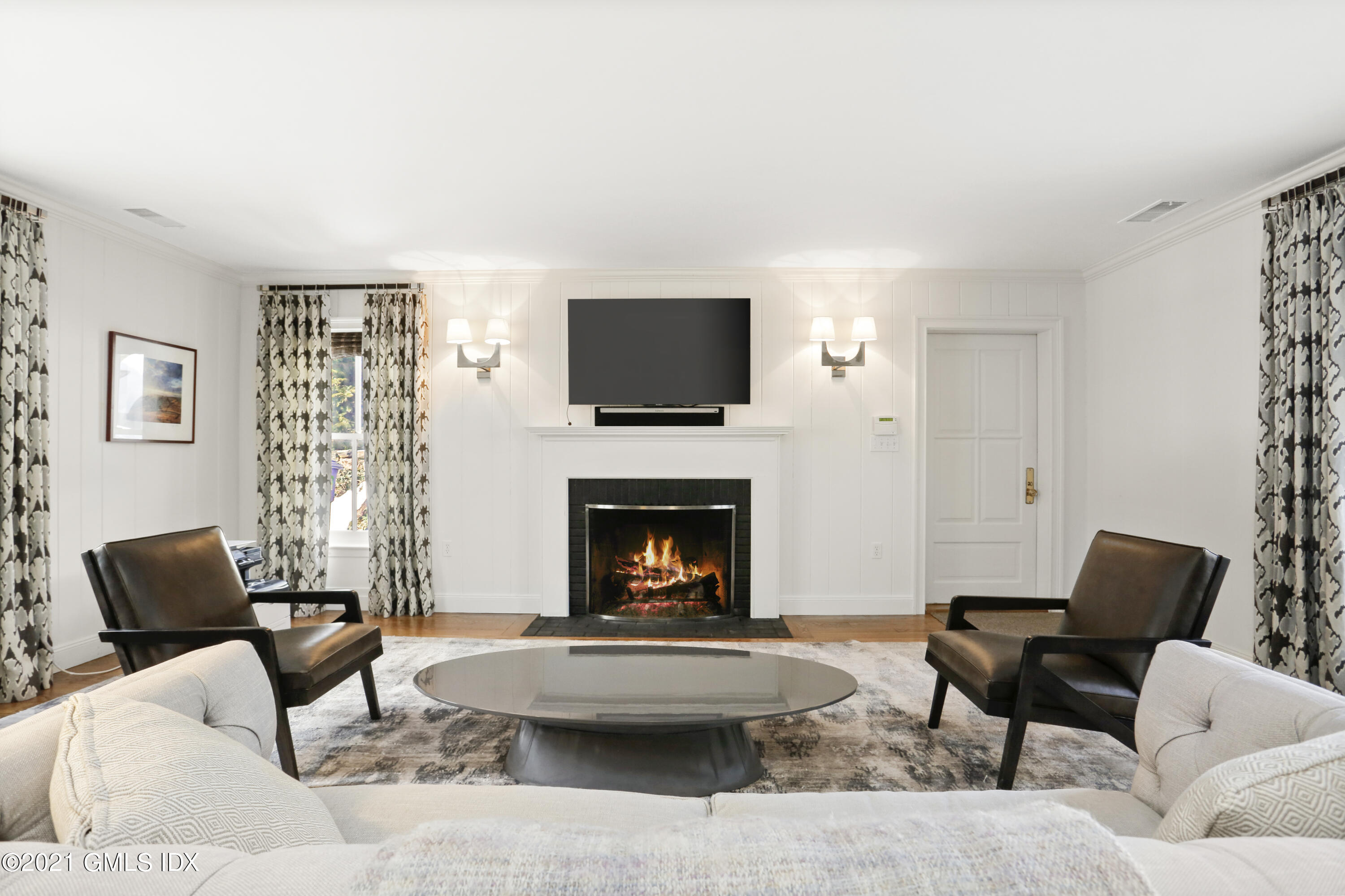 6 Golf Club Road Greenwich, CT 06830 - Photo 7 of 29 a living room with furniture a fireplace and a flat screen tv