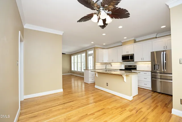 a kitchen with stainless steel appliances granite countertop a refrigerator and microwave