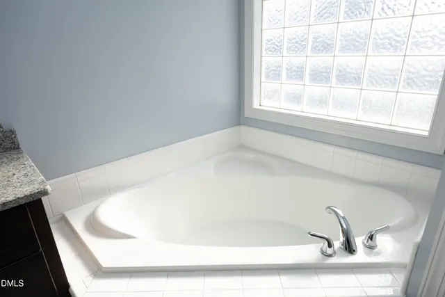 a white bath tub sitting in a bathroom
