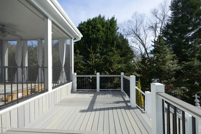 a view of balcony with wooden floor and fence