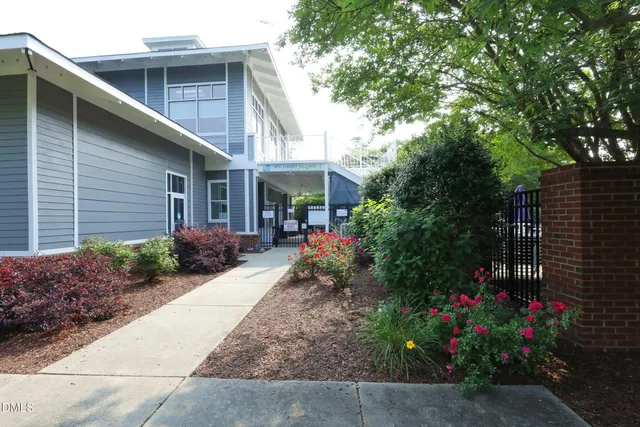 a view of a chair and table in backyard of house