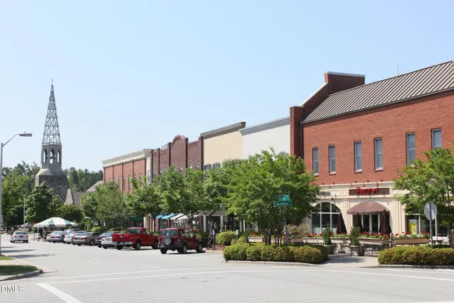 a front view of a building with plants
