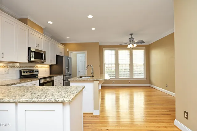 a kitchen with sink refrigerator and microwave