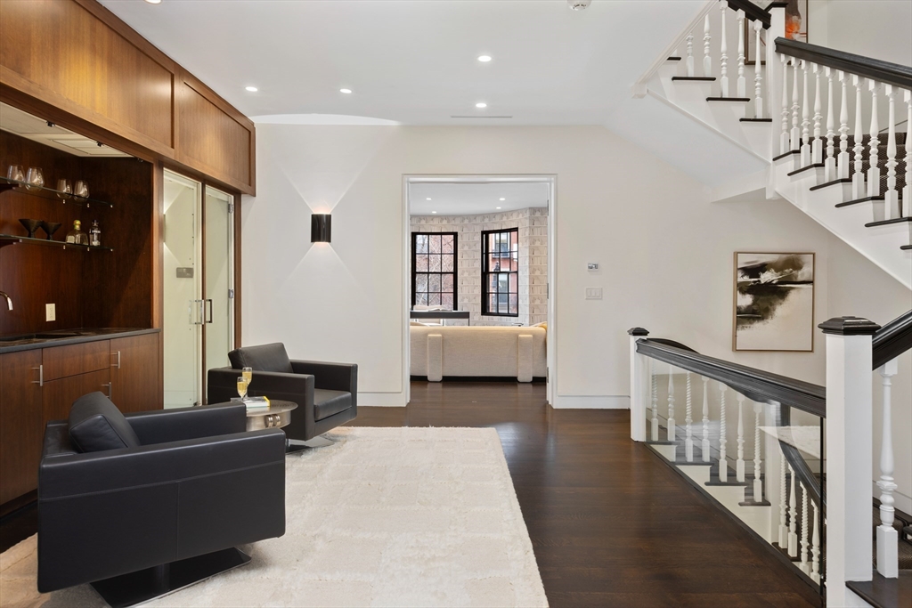 410 Beacon Street Boston, MA 02115 - Photo 12 of 35 a living room with furniture and stairs