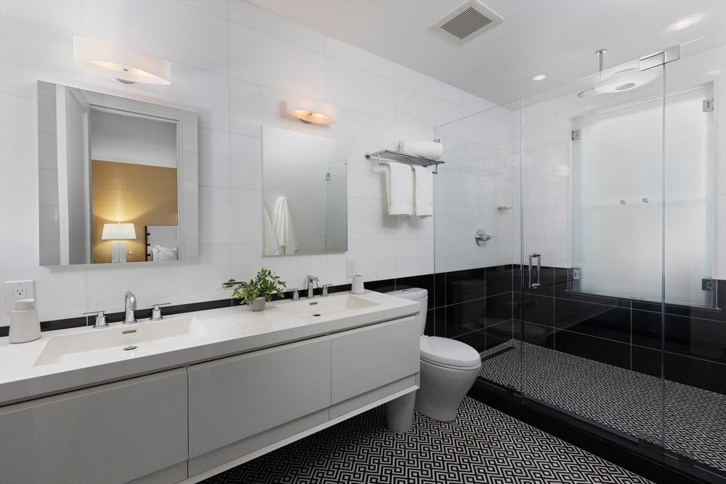 410 Beacon Street Boston, MA 02115 - Photo 14 of 35 a bathroom with a double vanity sink toilet mirror and bathtub