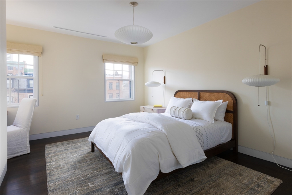 410 Beacon Street Boston, MA 02115 - Photo 15 of 35 a bedroom with a bed and wooden floor