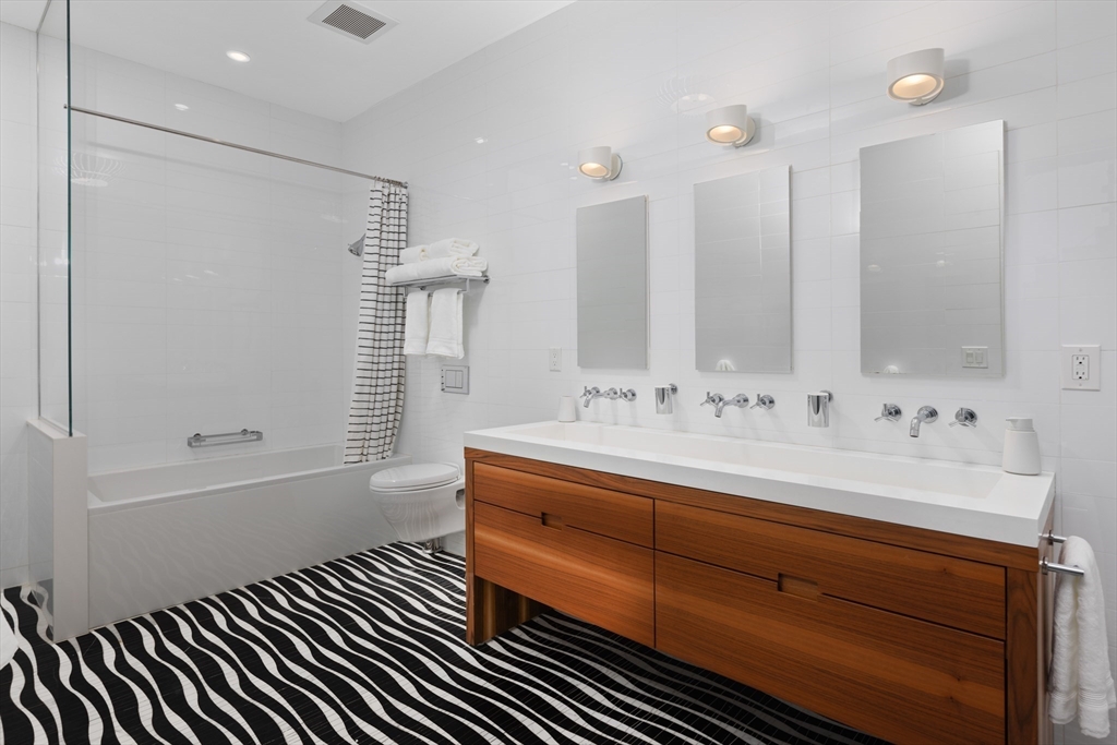 410 Beacon Street Boston, MA 02115 - Photo 16 of 35 a bathroom with a sink and a mirror