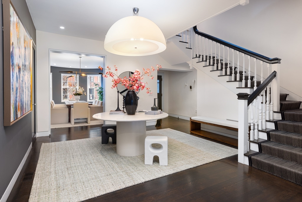 410 Beacon Street Boston, MA 02115 - Photo 2 of 35 a dining room with wooden floor and a chandelier