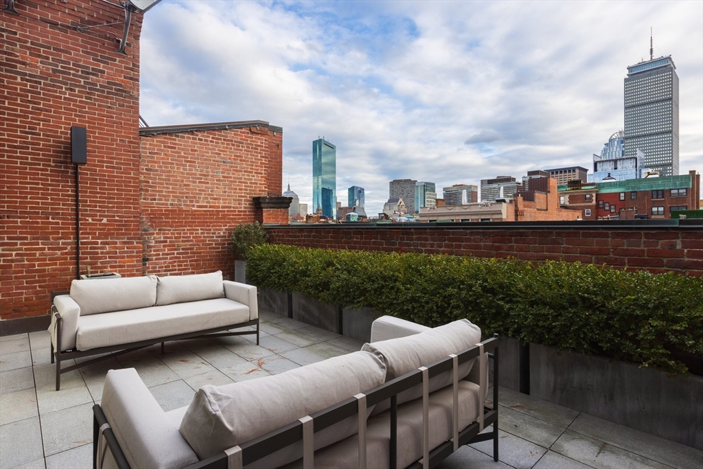 410 Beacon Street Boston, MA 02115 - Photo 28 of 35 a view of a terrace with couches chairs and a yard