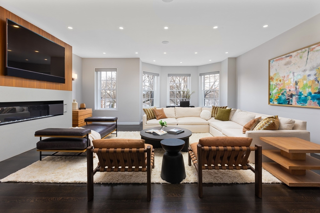 410 Beacon Street Boston, MA 02115 - Photo 10 of 35 a living room with furniture a flat screen tv and kitchen view