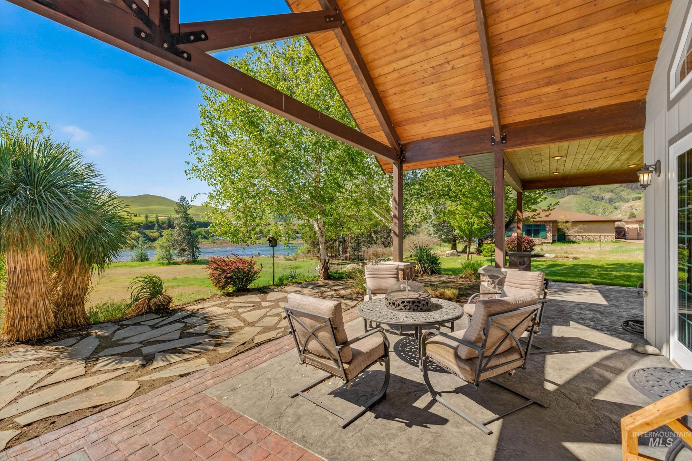 113 Deford Road White Bird, ID 83554 - Photo 29 of 49 Expansive outdoor patio area featuring a stained concrete surface, a red brick border, and a natural stone pathway