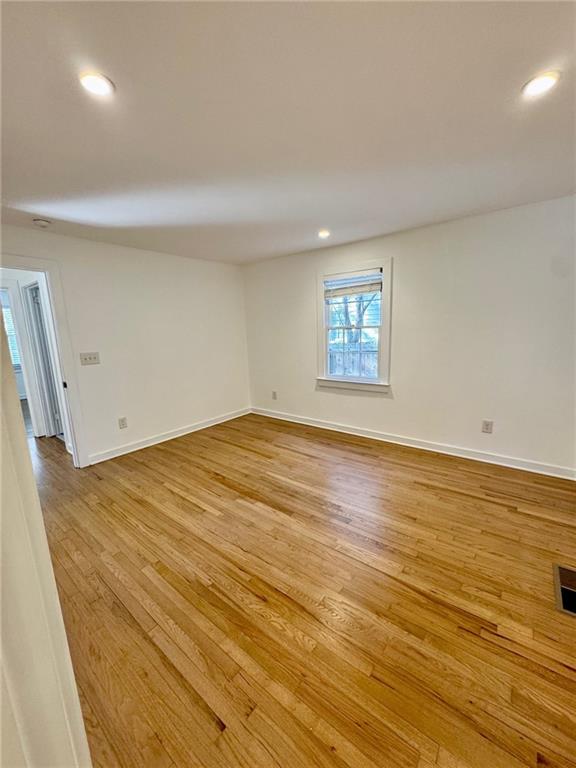 635 Valley Brook Road Decatur, GA 30033 - Photo 13 of 17 an empty room with wooden floor and window