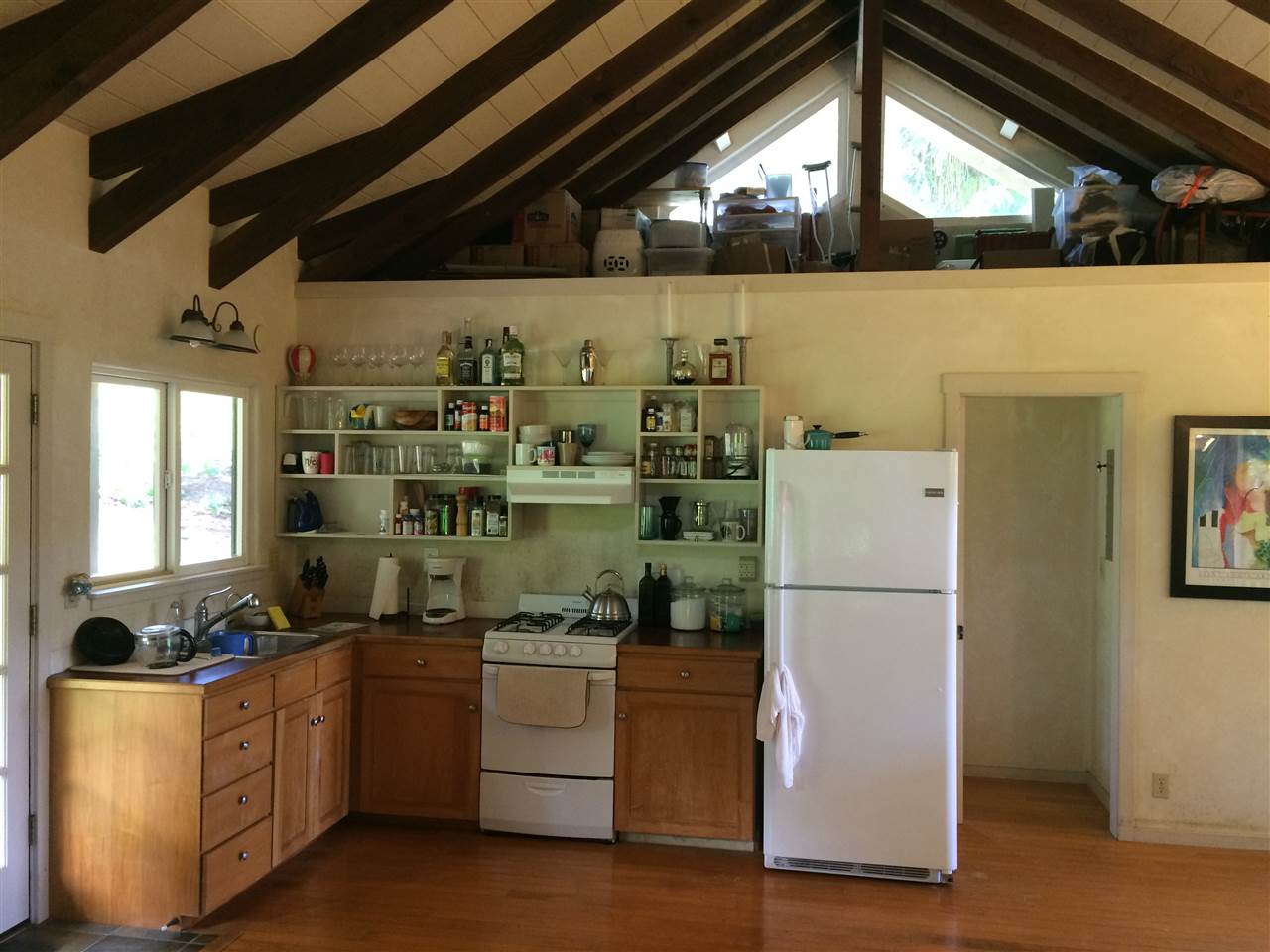 10 Honokaupu Place Haiku, HI 96708 - Photo 3 of 23 a kitchen with refrigerator a stove and cabinets