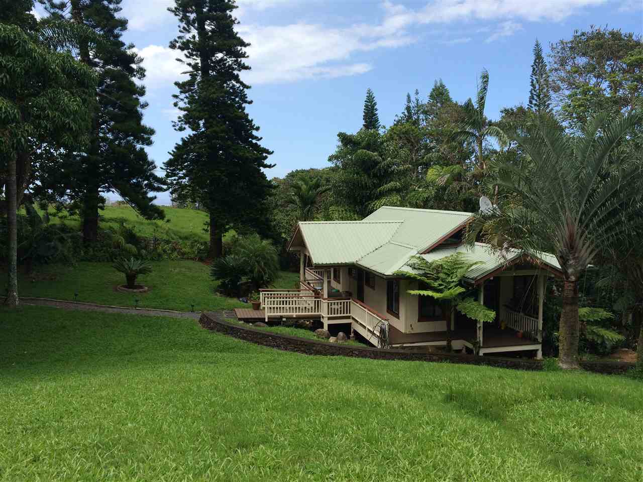 10 Honokaupu Place Haiku, HI 96708 - Photo 9 of 23 a view of a table and chairs under an umbrella