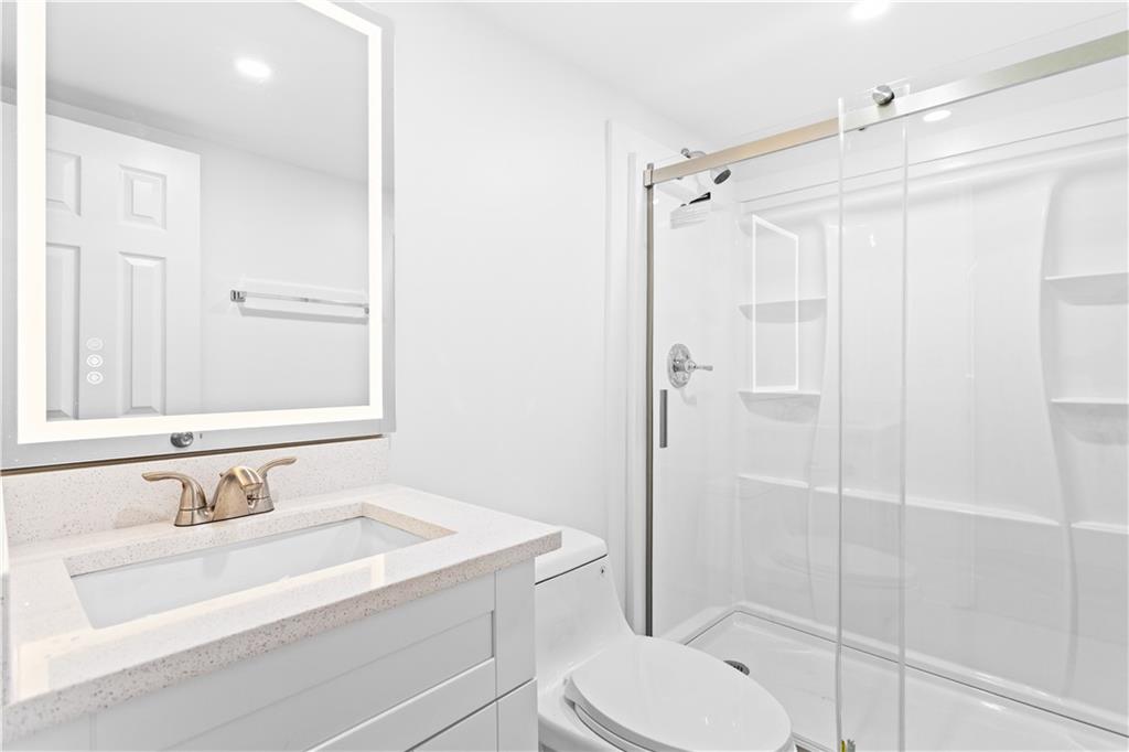 2304 South Hairston Road Decatur, GA 30035 - Photo 15 of 24 a bathroom with a sink toilet vanity and shower