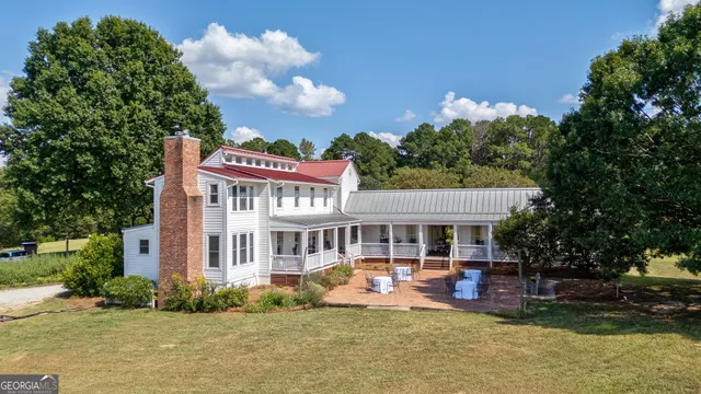 a view of a house with swimming pool and porch