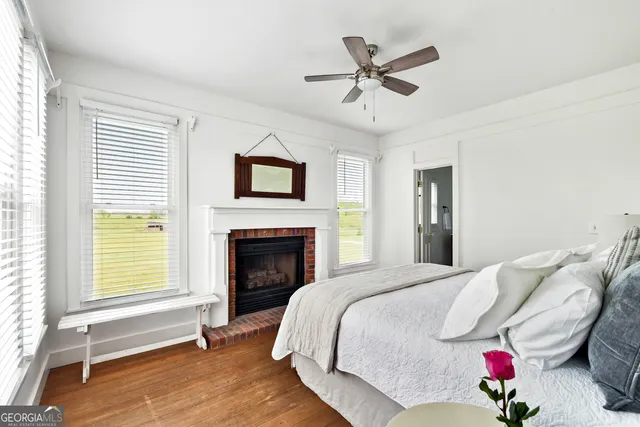 a bathroom with a toilet sink vanity and mirror