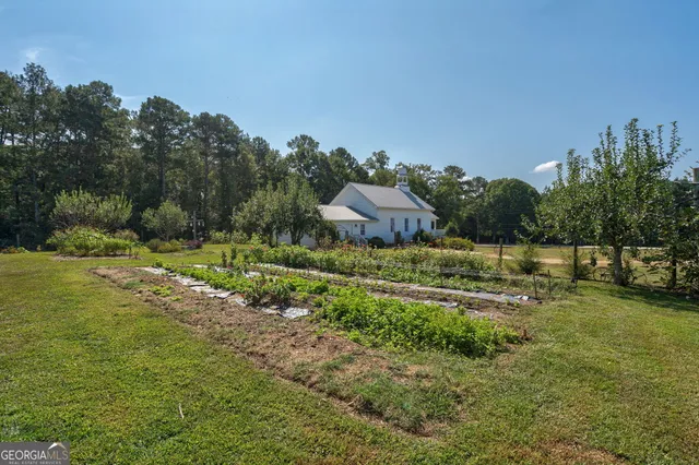 a bathroom with a sink mirror and shower