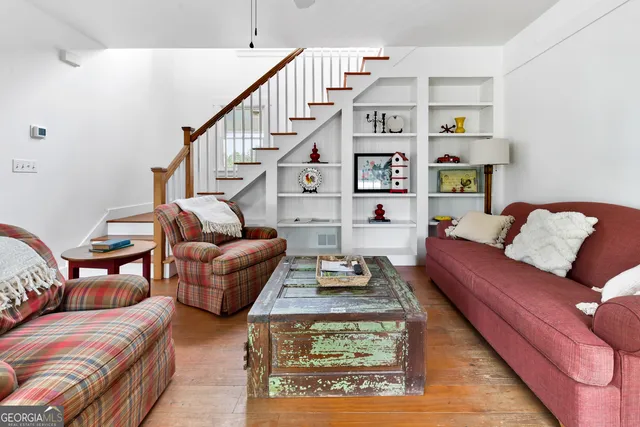 a view of a house with sitting area and wooden floor
