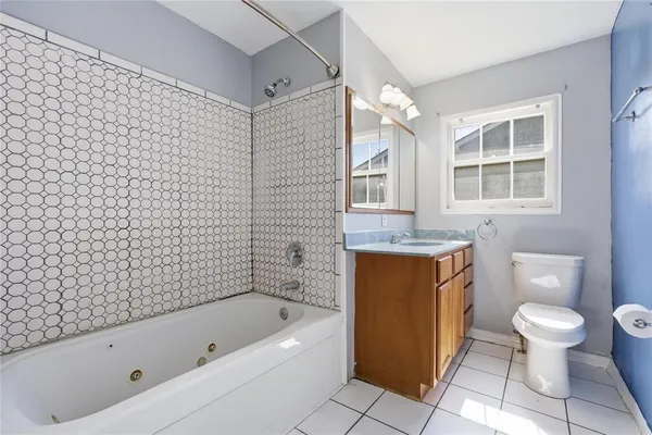 a bathroom with a toilet bathtub and shower
