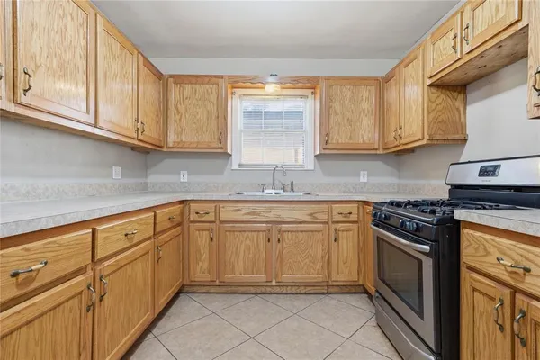 a kitchen with granite countertop cabinets stainless steel appliances and a sink