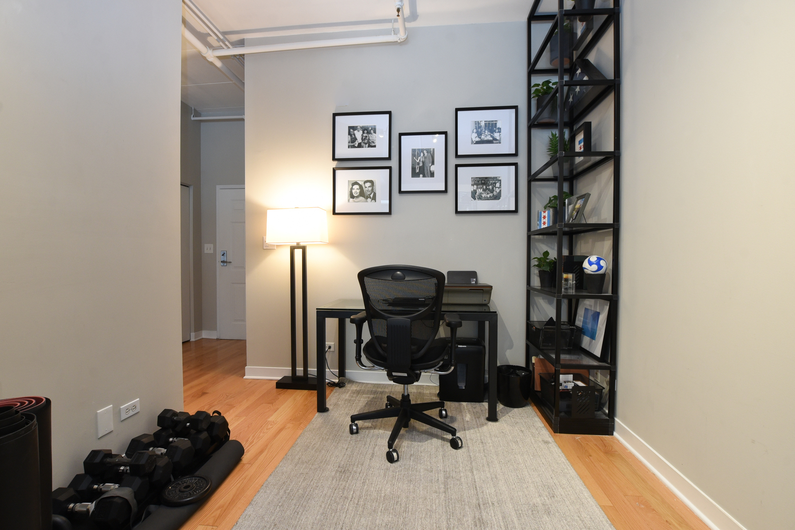 920 West Madison Street, Unit D4 Chicago, IL 60607 - Photo 15 of 34 a view of a workspace with furniture and gym equipment