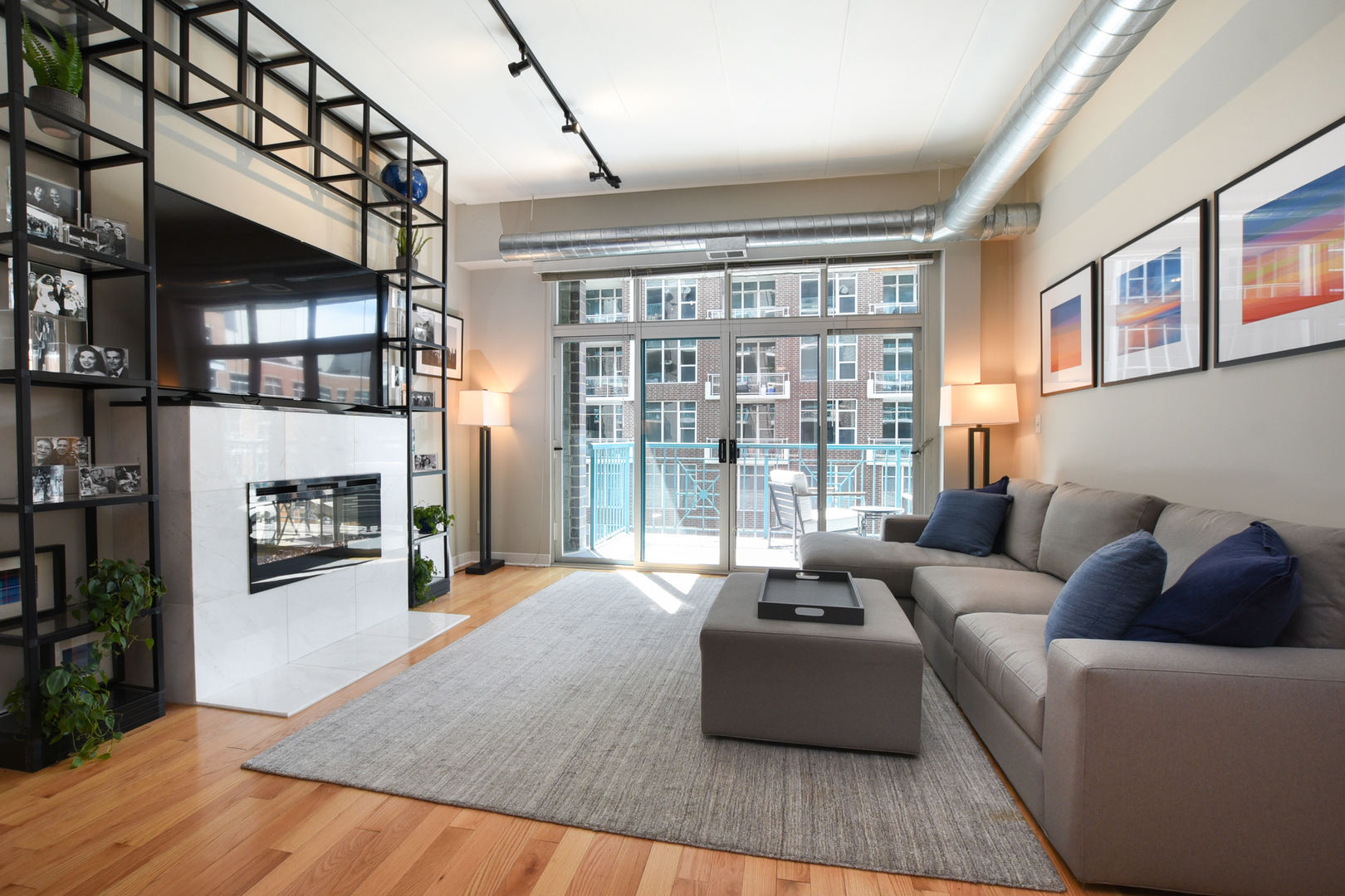 920 West Madison Street, Unit D4 Chicago, IL 60607 - Photo 2 of 34 a living room with furniture fireplace and a floor to ceiling window