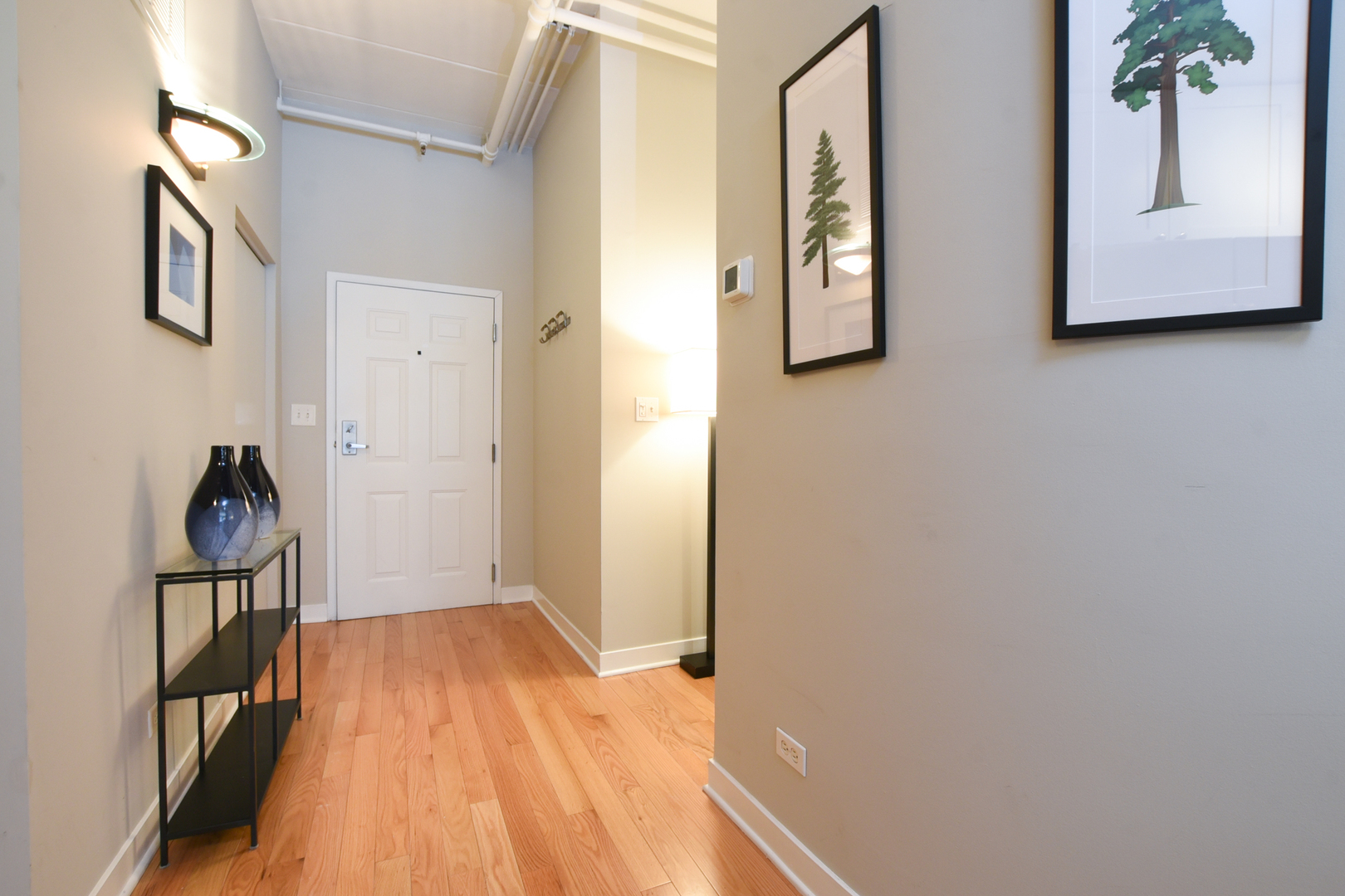 920 West Madison Street, Unit D4 Chicago, IL 60607 - Photo 24 of 34 a view of a hallway with wooden floor and stairs