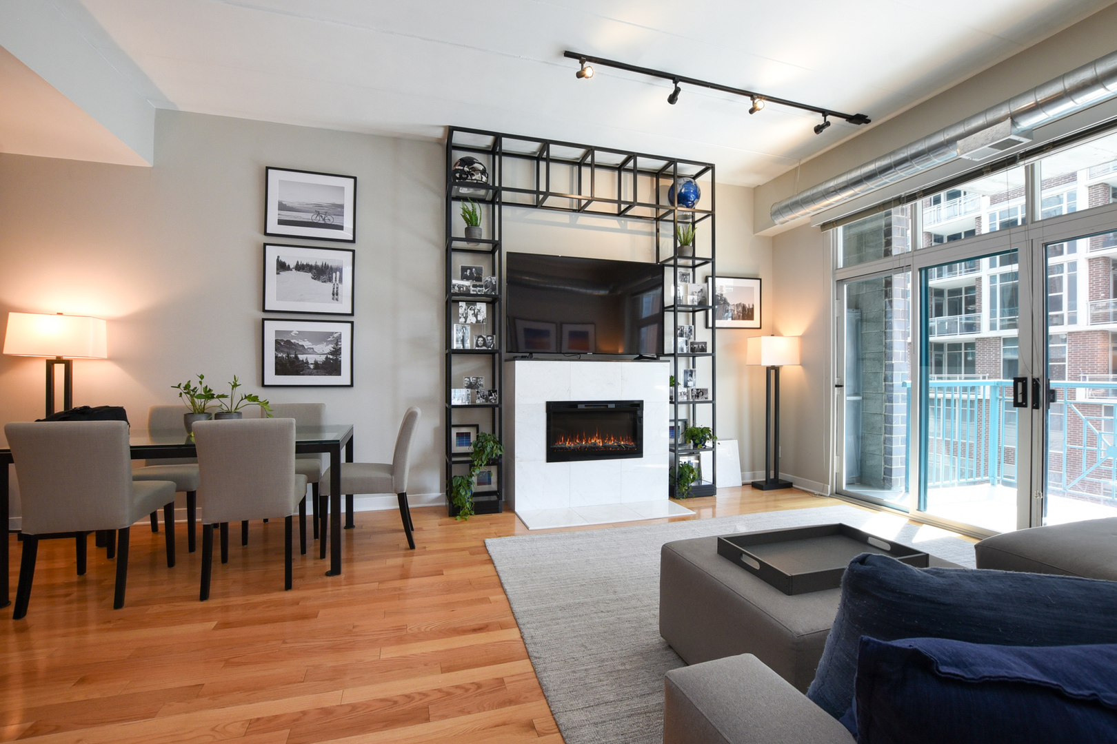 920 West Madison Street, Unit D4 Chicago, IL 60607 - Photo 5 of 34 a living room with furniture a fireplace and a flat screen tv