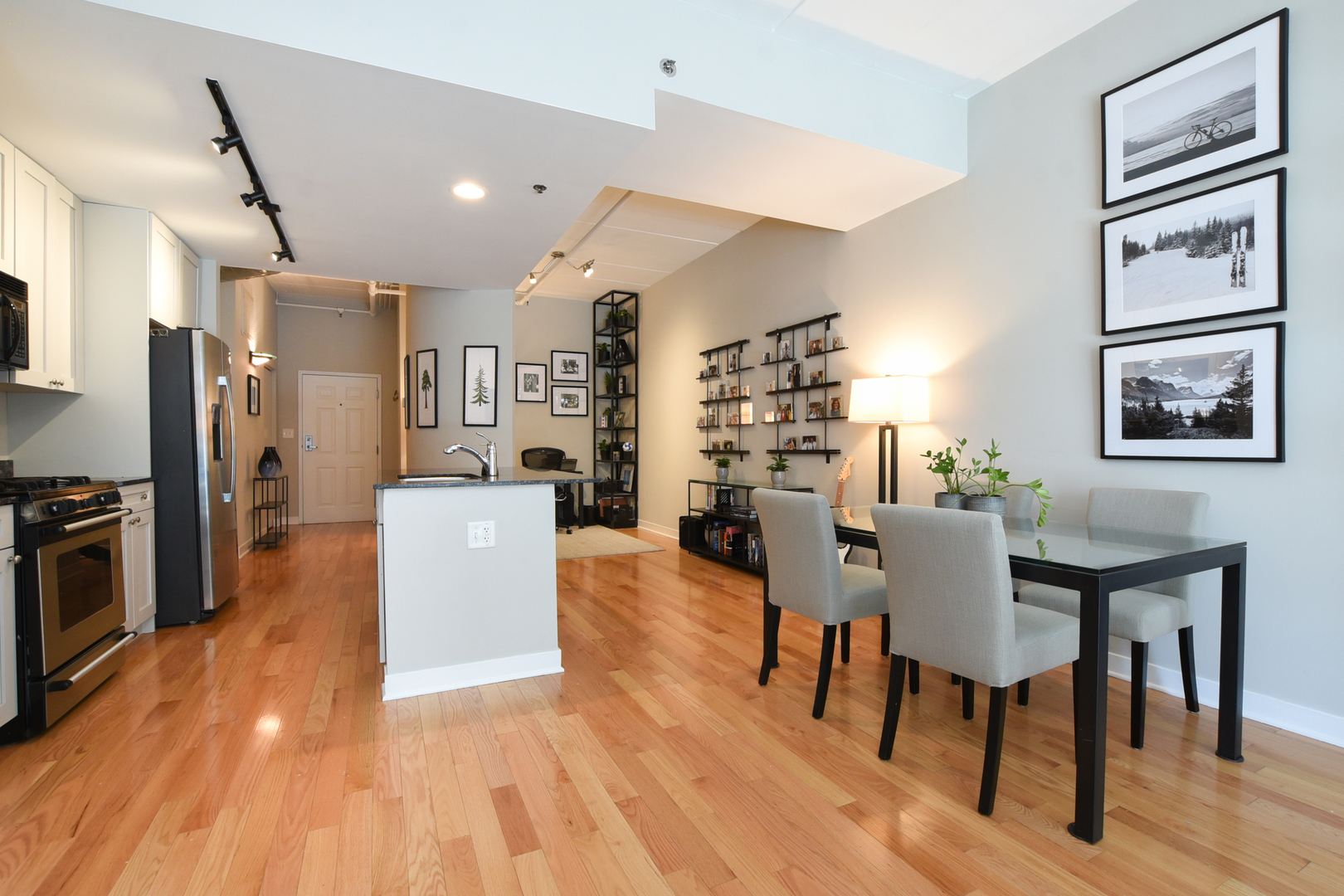 920 West Madison Street, Unit D4 Chicago, IL 60607 - Photo 7 of 34 a living room with stainless steel appliances furniture a dining table and chairs with wooden floor