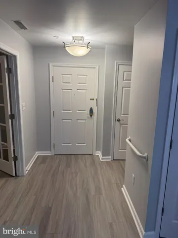 wooden floor in an empty room with a mirror