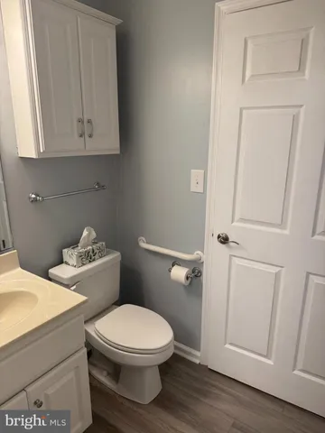 a white toilet sitting next to a bathroom sink