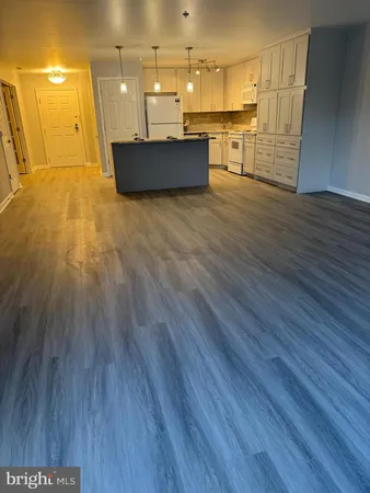 a view of a kitchen with wooden floor