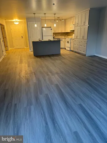 a view of a kitchen with wooden floor