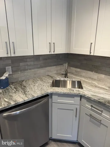 a kitchen with a sink and cabinets