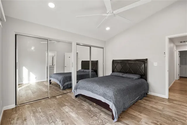 a bedroom with a large bed and a chandelier