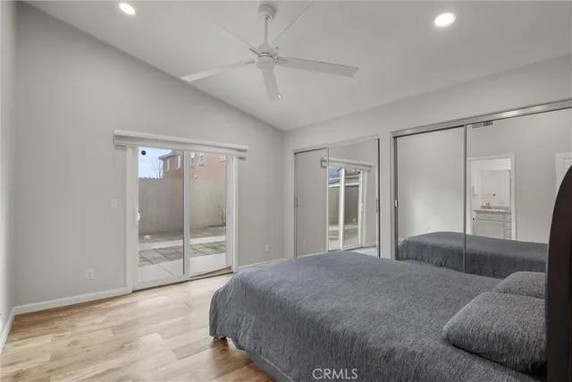 a spacious bedroom with a bed and glass door