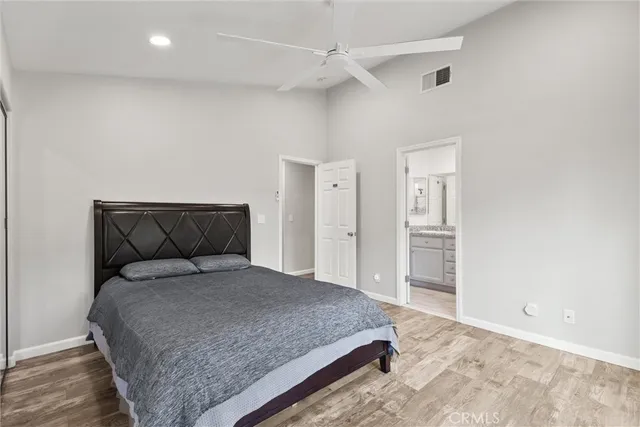 a spacious bedroom with a bed and a chandelier