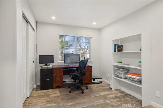 a view of a workspace with furniture and a window