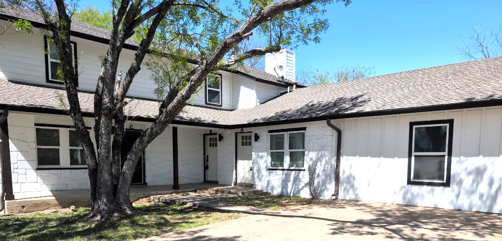 3413 Lynridge Drive, Unit B Austin, TX 78723 - Photo 1 of 23 a front view of a house with a yard