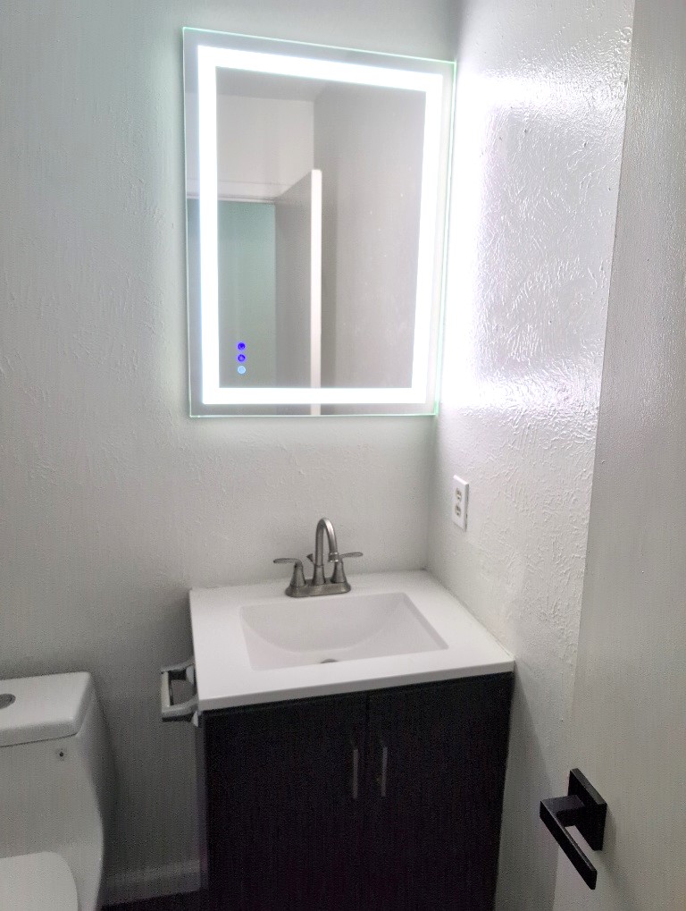 3413 Lynridge Drive, Unit B Austin, TX 78723 - Photo 16 of 23 Half bathroom featuring toilet, vanity, and a textured wall