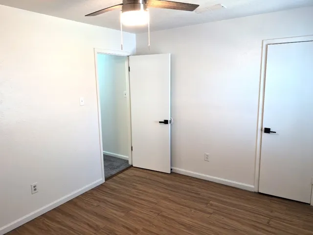 a bathroom with a granite countertop toilet and a sink