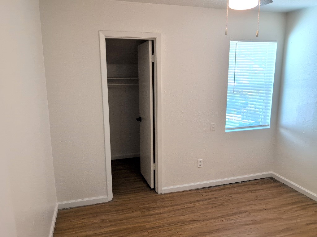 3413 Lynridge Drive, Unit B Austin, TX 78723 - Photo 22 of 23 a view of an empty room with wooden floor and closet