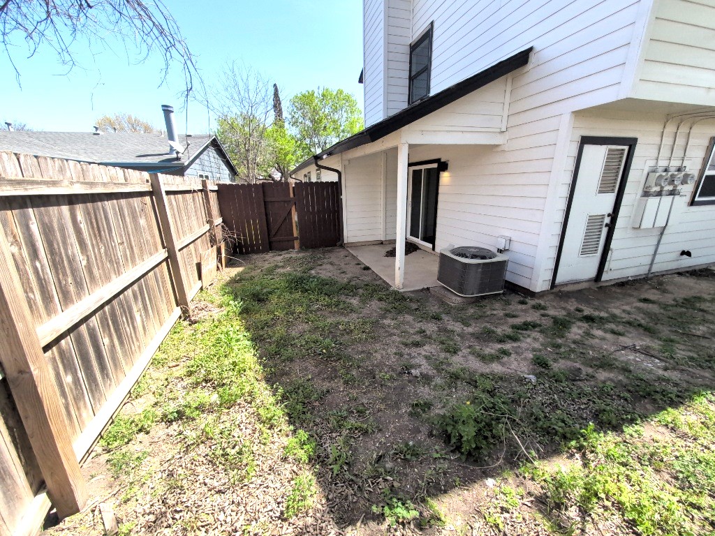 3413 Lynridge Drive, Unit B Austin, TX 78723 - Photo 23 of 23 View of yard featuring cooling unit, a fenced backyard, and a patio
